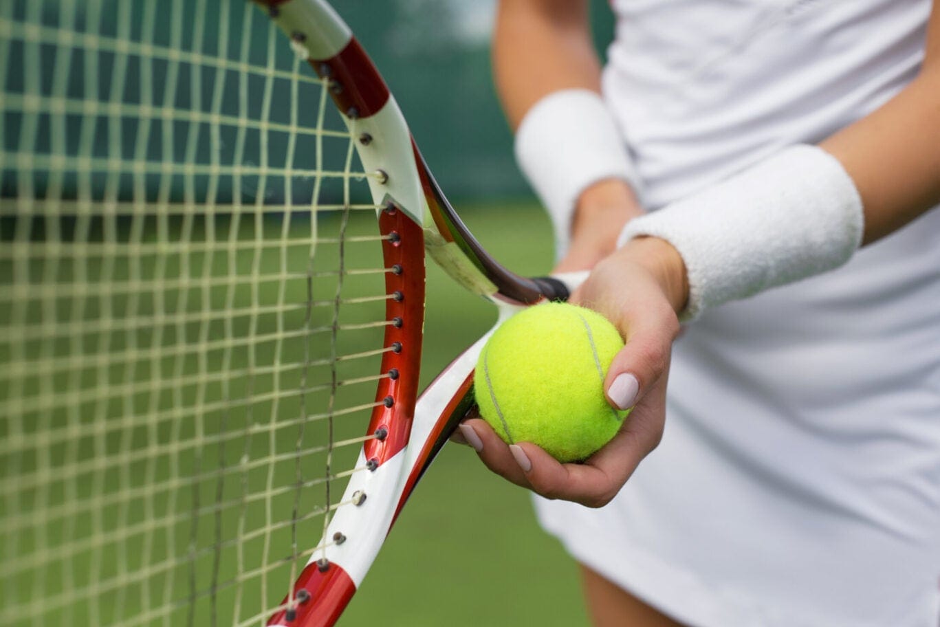 Tennis,Player,Holding,Racket,And,Ball,In,Hands