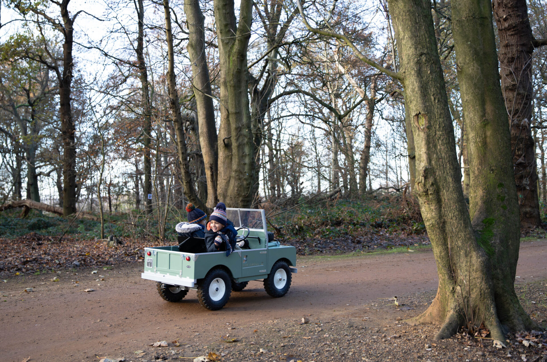 Kids in a mini landie. Land rover